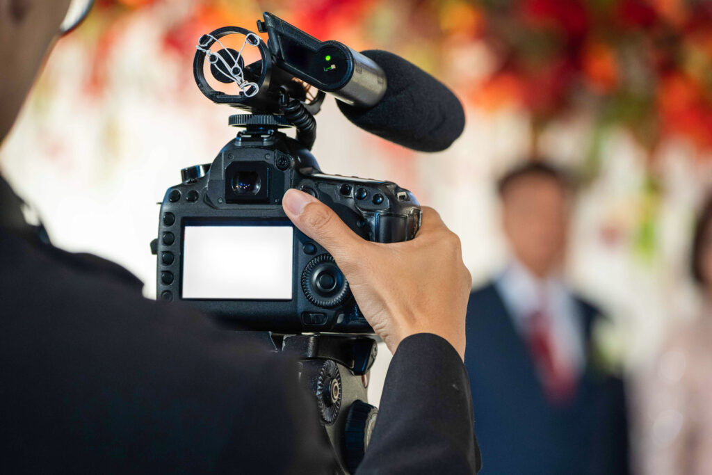 Videographer in backside are shooting and recording video in Wedding Event.